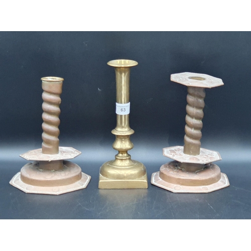 63 - A pair of antique brass Heemskirk style Candlesticks with spiral columns fruit embossed on octagonal... 