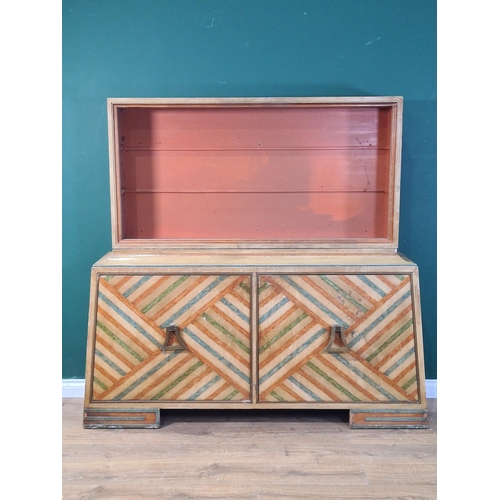 692 - An Art Deco style Bookcase the base fitted with pair of cupboard doors with geometric designs with h... 