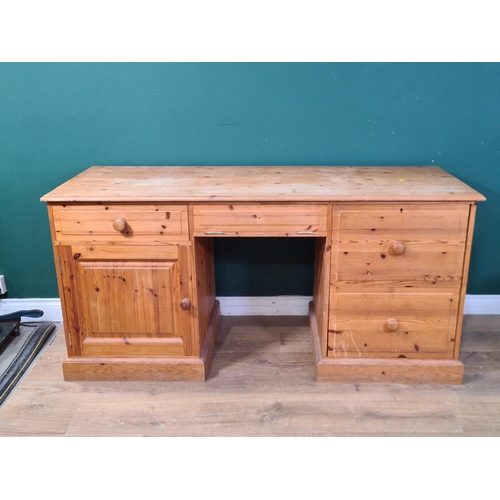 695 - A modern pine Pedestal Desk fitted drawers and cupboard, on plinth bases, 5ft 3