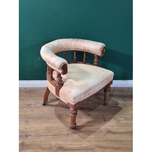 698 - A cream upholstered spindle back mahogany framed Tub Chair on turned front supports and castors. (R7... 