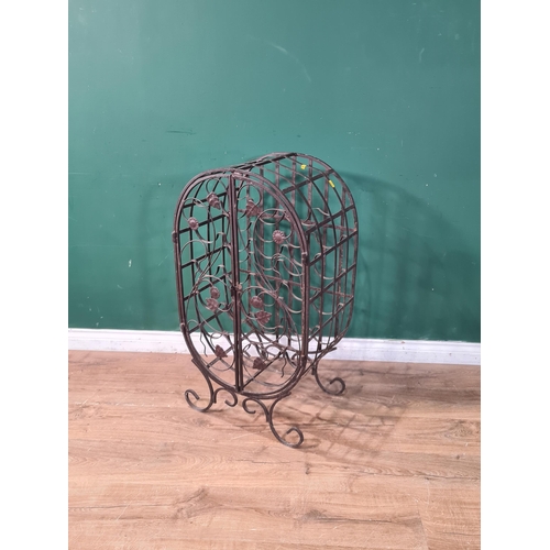 703 - A wrought iron Wine Cage with pair of scrolled and leafed decorated doors on scrolled supports, 3ft ... 