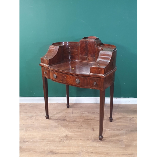 705 - A mahogany Ladies Writing Desk, the raised surround with fitted cupboard flanked by drawers and two ... 