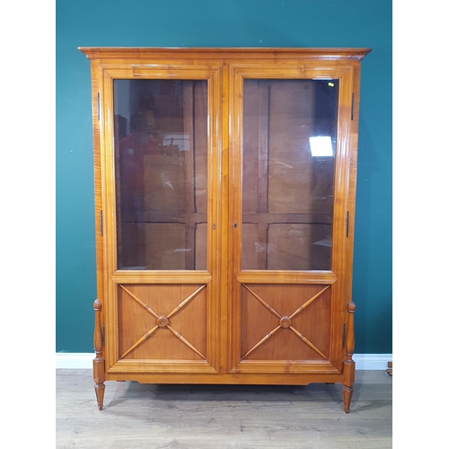 707 - A reproduction glazed Bookcase with pair of glazed and panelled doors enclosing adjustable shelves a... 