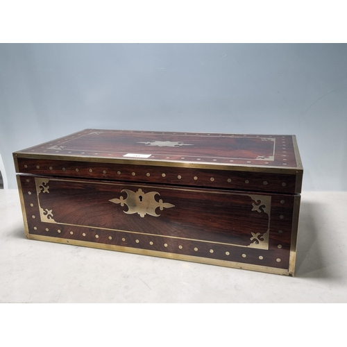 745 - A fine rosewood Writing Box with brass inlay, having a pair of brass candlesticks mounted when open,... 