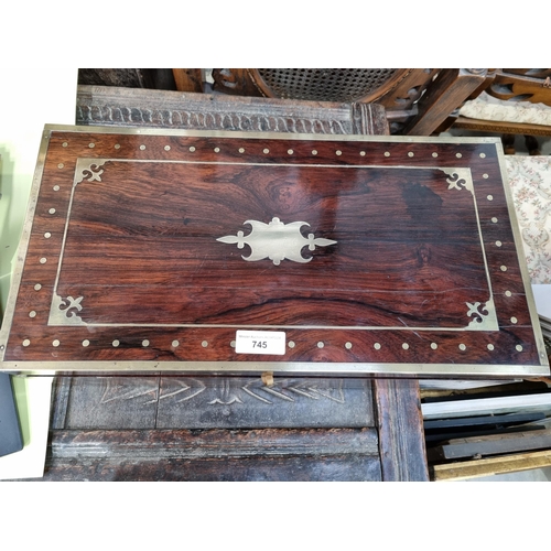 745 - A fine rosewood Writing Box with brass inlay, having a pair of brass candlesticks mounted when open,... 