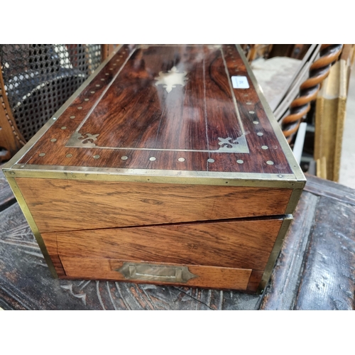 745 - A fine rosewood Writing Box with brass inlay, having a pair of brass candlesticks mounted when open,... 