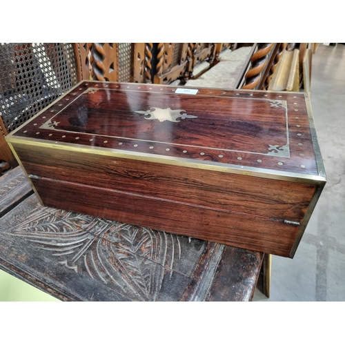 745 - A fine rosewood Writing Box with brass inlay, having a pair of brass candlesticks mounted when open,... 