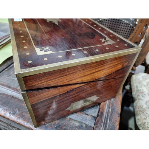 745 - A fine rosewood Writing Box with brass inlay, having a pair of brass candlesticks mounted when open,... 