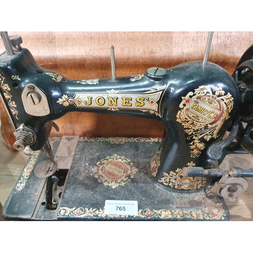 765 - A cast iron Singer Sewing Machine, and a Jones Sewing Machine, (R9)