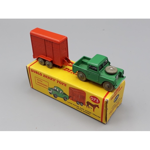 1043 - A boxed Dublo Dinky Toys 073 Land Rover with the green ramp, M, box Ex plus with shop sticker to one... 