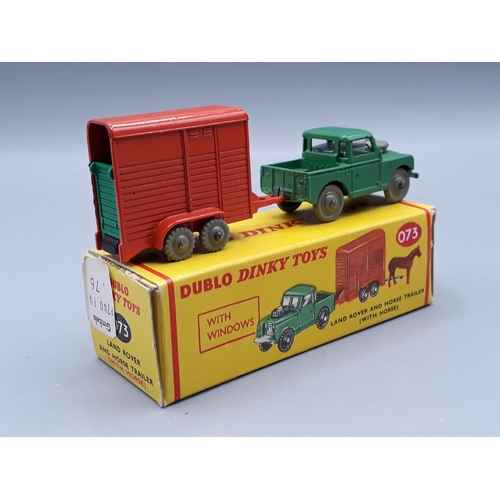 1043 - A boxed Dublo Dinky Toys 073 Land Rover with the green ramp, M, box Ex plus with shop sticker to one... 