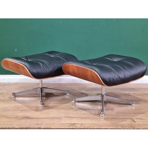 459 - A pair of Footstools designed by Charles and Ray Eames with black leather seats on plywood frames an... 