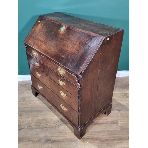 495 - An antique oak Bureau with fitted interior including a well above a dummy drawer, two short and two ... 