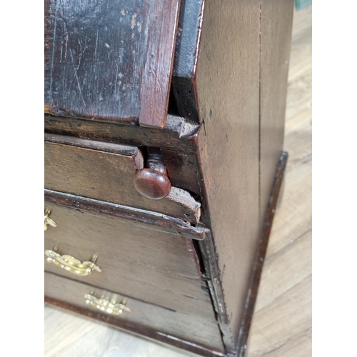 495 - An antique oak Bureau with fitted interior including a well above a dummy drawer, two short and two ... 