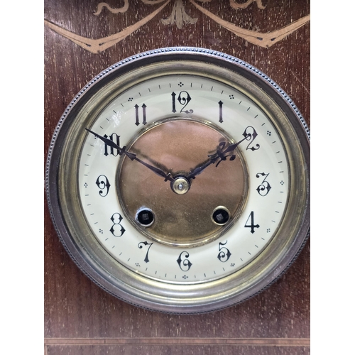 497 - An Edwardian mahogany Mantle Clock with satinwood inlay, circular Dial, striking on a gong, complete... 