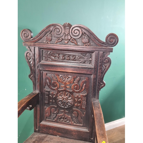 501 - A carved oak Victorian Wainscot Armchair with carved top rail with carved panelled back bearing the ... 