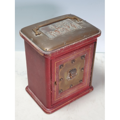 11 - A red leather covered Jewellery Casket the top with swing handle and a plaque depicting winged Cheru... 