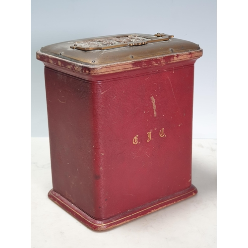 11 - A red leather covered Jewellery Casket the top with swing handle and a plaque depicting winged Cheru... 