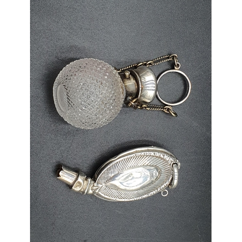 110 - A white metal lidded glass Pendant Scent Bottle, with chain, and a silver Teether, Chester 1909, A/F