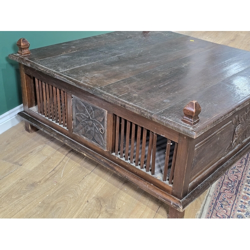 186 - A large oak Coffee Table with carved panels and doors to the sides, 3ft 10in x 3ft 11in x 1ft 7in H,... 