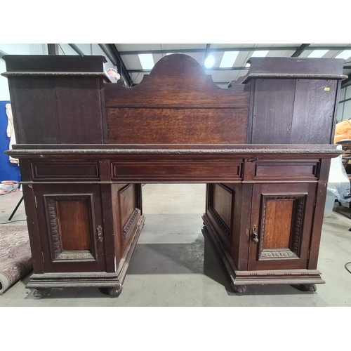 187 - A Victorian carved oak Pedestal Desk, the raised top fitted letter compartment and pigeonholes with ... 