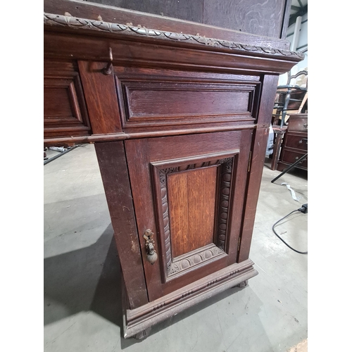 187 - A Victorian carved oak Pedestal Desk, the raised top fitted letter compartment and pigeonholes with ... 