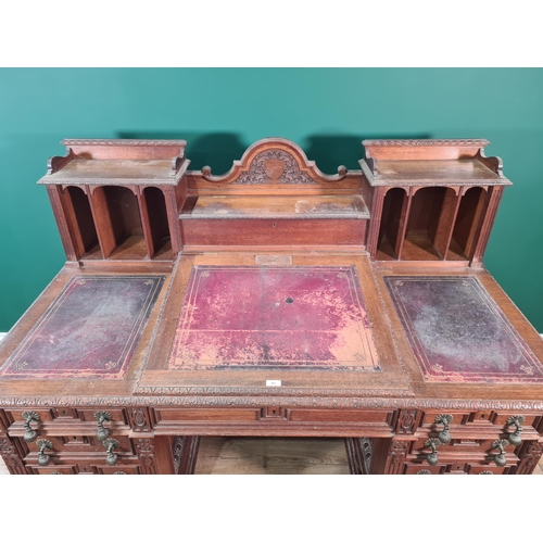 187 - A Victorian carved oak Pedestal Desk, the raised top fitted letter compartment and pigeonholes with ... 