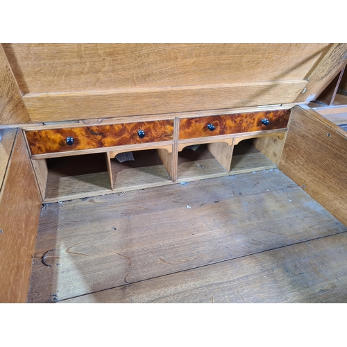 187 - A Victorian carved oak Pedestal Desk, the raised top fitted letter compartment and pigeonholes with ... 