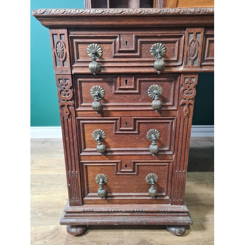 187 - A Victorian carved oak Pedestal Desk, the raised top fitted letter compartment and pigeonholes with ... 