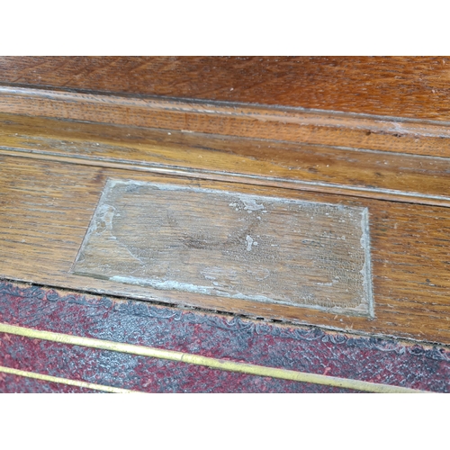 187 - A Victorian carved oak Pedestal Desk, the raised top fitted letter compartment and pigeonholes with ... 