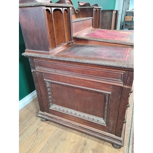 187 - A Victorian carved oak Pedestal Desk, the raised top fitted letter compartment and pigeonholes with ... 