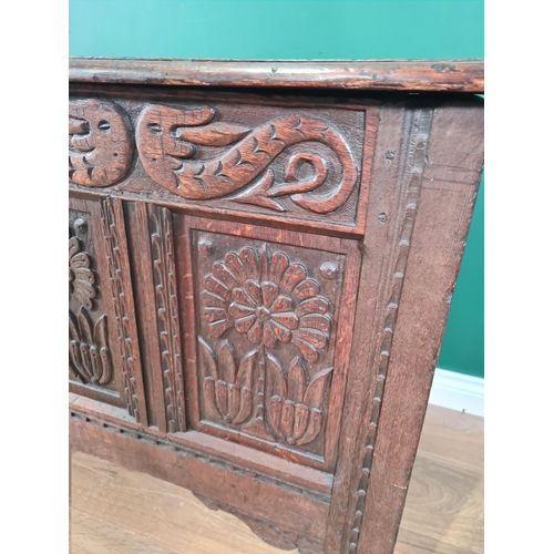 27 - A 17th Century oak Coffer with plank lid above dragon carved frieze flanking initials I.B and dated ... 