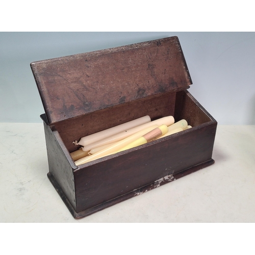 34 - An antique oak Candle Box with hinged cover and containing candles, 14 1/2in W, (R6)