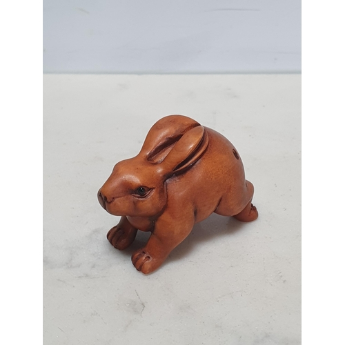 4 - Two carved wood Netsuke in the form of a Rabbit and a Pig. (Cab).