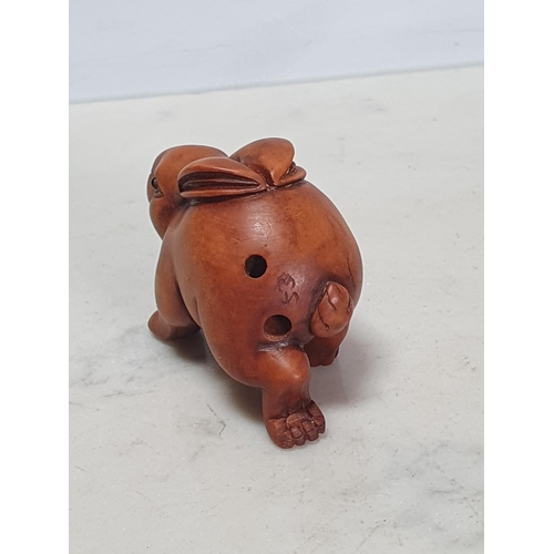 4 - Two carved wood Netsuke in the form of a Rabbit and a Pig. (Cab).