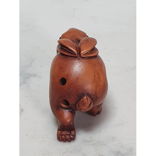 4 - Two carved wood Netsuke in the form of a Rabbit and a Pig. (Cab).