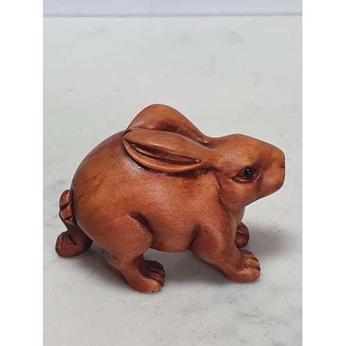 4 - Two carved wood Netsuke in the form of a Rabbit and a Pig. (Cab).