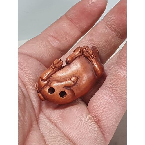 4 - Two carved wood Netsuke in the form of a Rabbit and a Pig. (Cab).