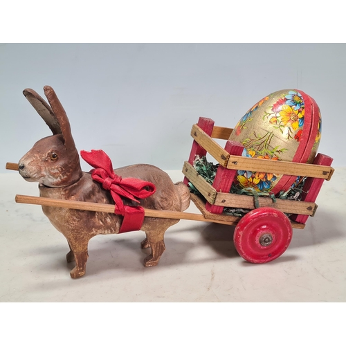 40 - A German Easter Rabbit pulling a cart with Easter Egg, a carved wooden Dachshund and two plaster Dac... 