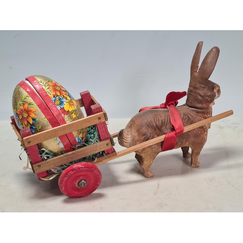 40 - A German Easter Rabbit pulling a cart with Easter Egg, a carved wooden Dachshund and two plaster Dac... 