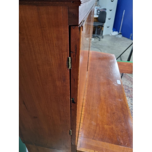 423 - A walnut and satinwood Desk Cabinet fitted pair of cupboard doors enclosing drawers and pigeonholes ... 