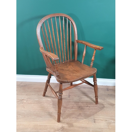 427 - An elm seated stickback Elbow Chair on turned supports and stretchers, (R5)