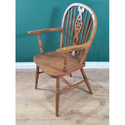 429 - An oak wheelback Elbow Chair with elm seat on turned supports and stretchers, (R5)