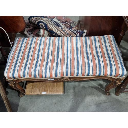 473 - A Victorian Footstool with striped upholstery on carved cabriole supports 2ft 10in W x 1ft 4in H (R2... 