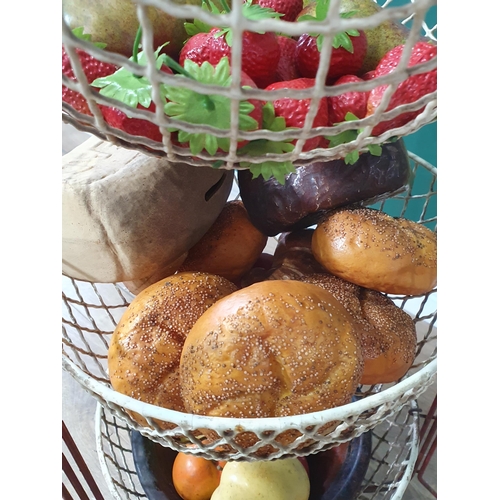 480 - A three-tier fruit and vegetable Stand containing a selection of simulated fruit and bread, (R6)