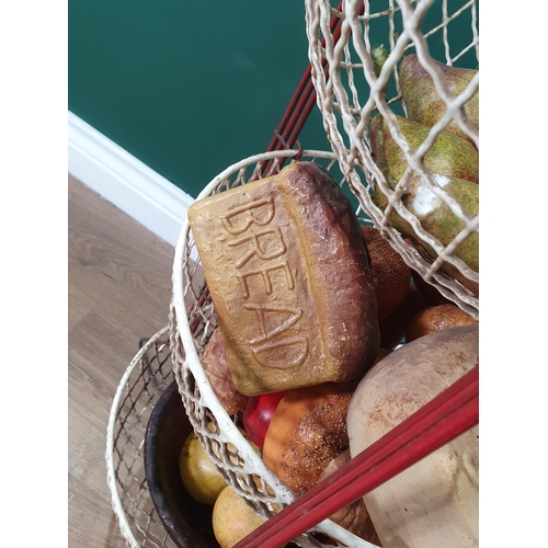 480 - A three-tier fruit and vegetable Stand containing a selection of simulated fruit and bread, (R6)