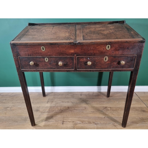 491 - An antique oak Desk with double hinged sloping front fitted two drawers on squared supports, 3ft 6in... 