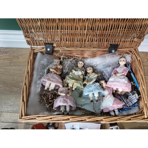 505 - A cloth Dolls in costume, a selection of Shoes, a Basket containing small Dolls, (R5)