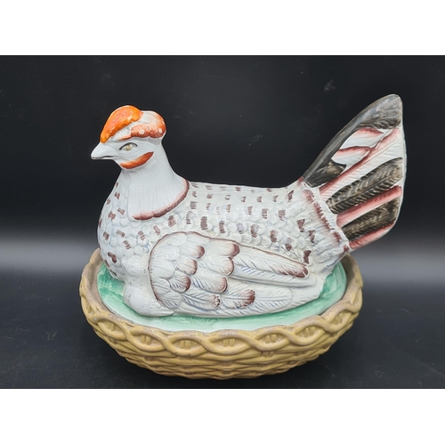 51 - A large pottery Hen Tureen and Cover with painted details, 9in,and two pottery Cow Creamers with pai... 