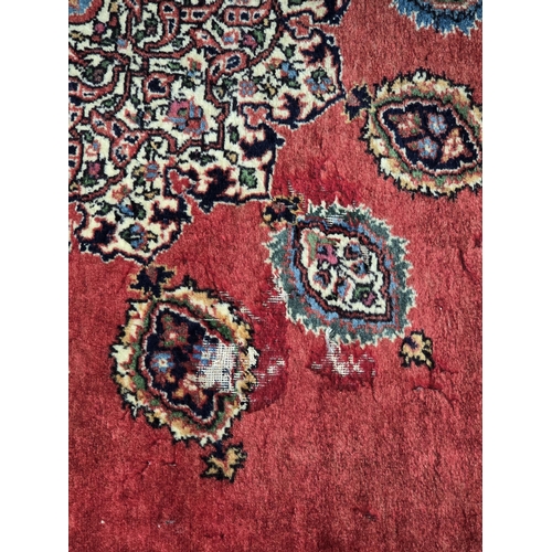 525 - A bordered Persian Rug with central medallion on a red ground, 7ft x 4ft 6in (R1)